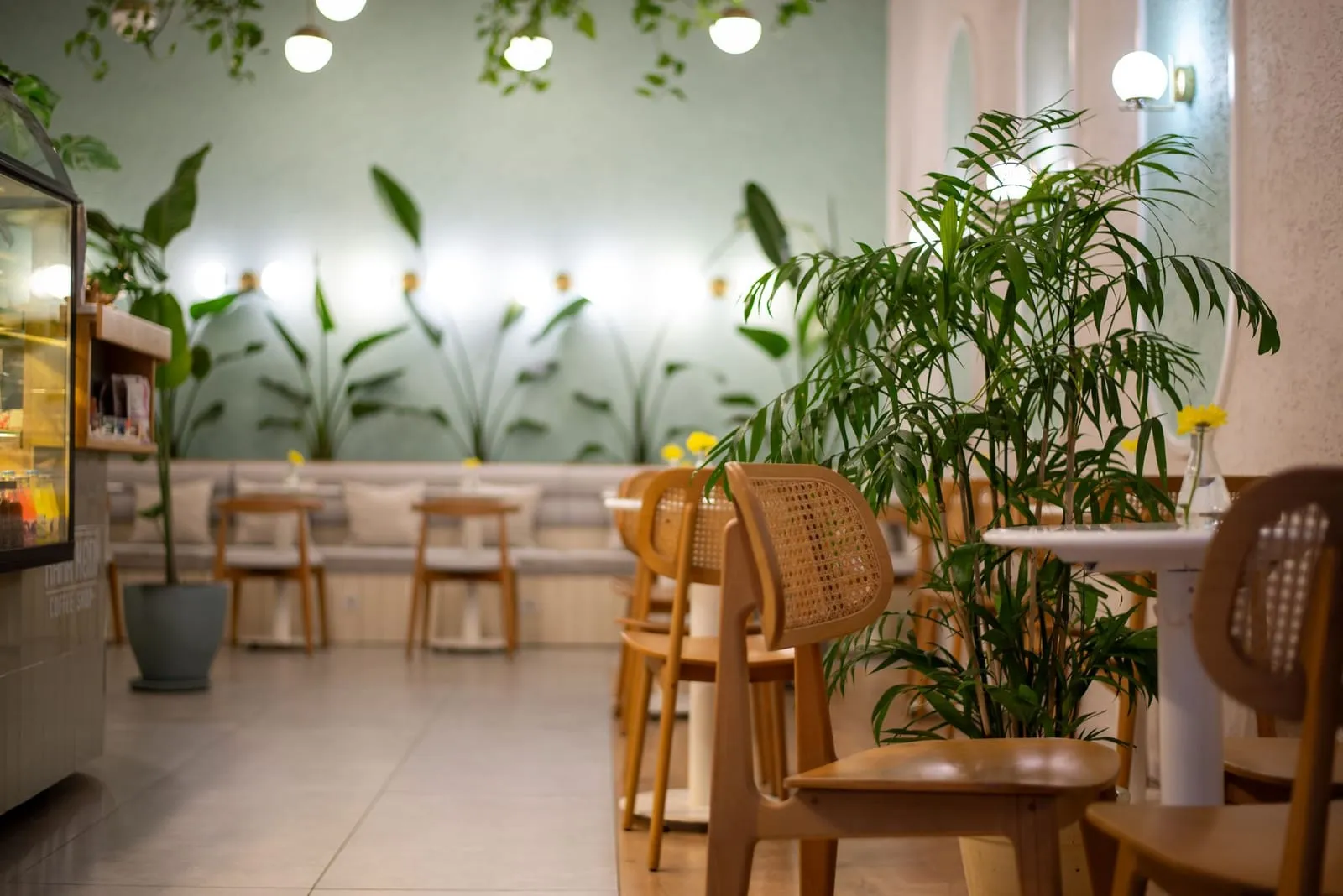 A cozy modern cafe with warm lighting and empty chairs, inviting connection.