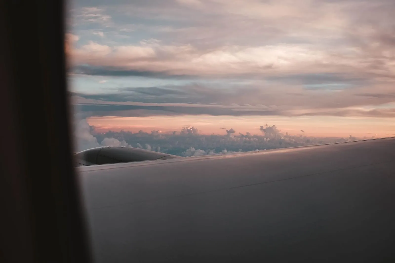 Clouds at sunset seen from an airplane window.