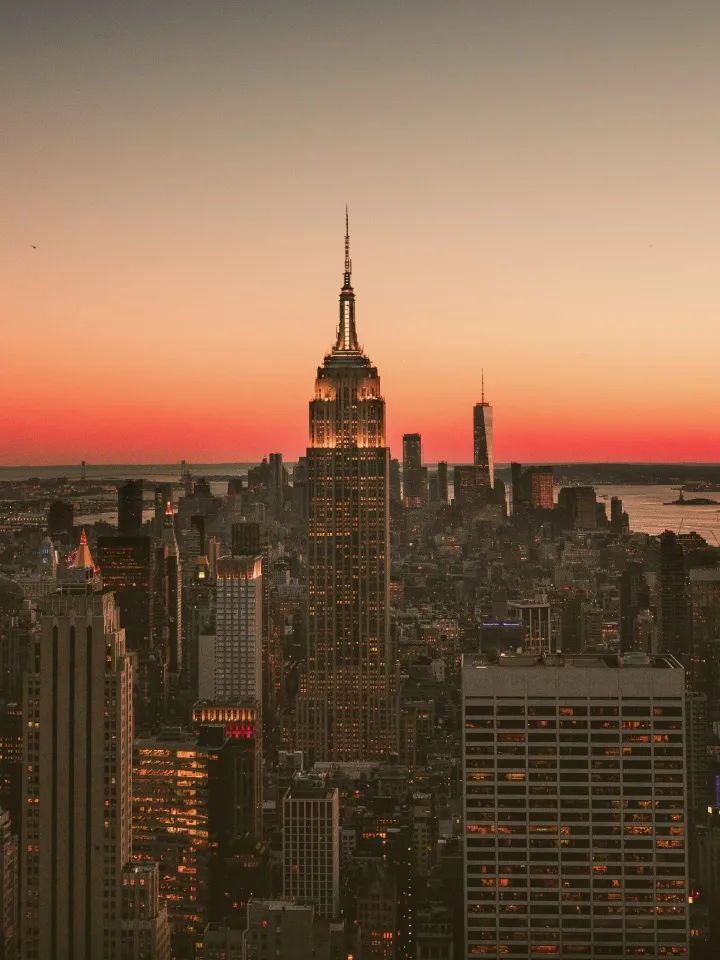 The Manhattan skyline at sunset, with the Empire State Building rising above the city